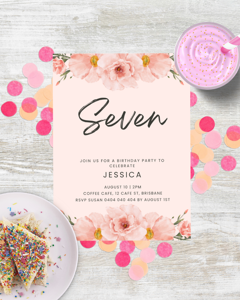 Birthday invitation featuring pink flowers, colorful confetti, and a slice of cake with sprinkles on a wooden surface.
