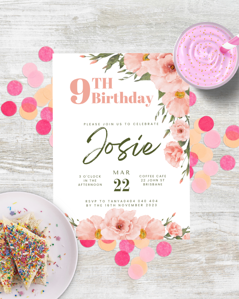 Colorful birthday invitation with floral accents, confetti, and a dessert on a plate, set on a wooden surface.