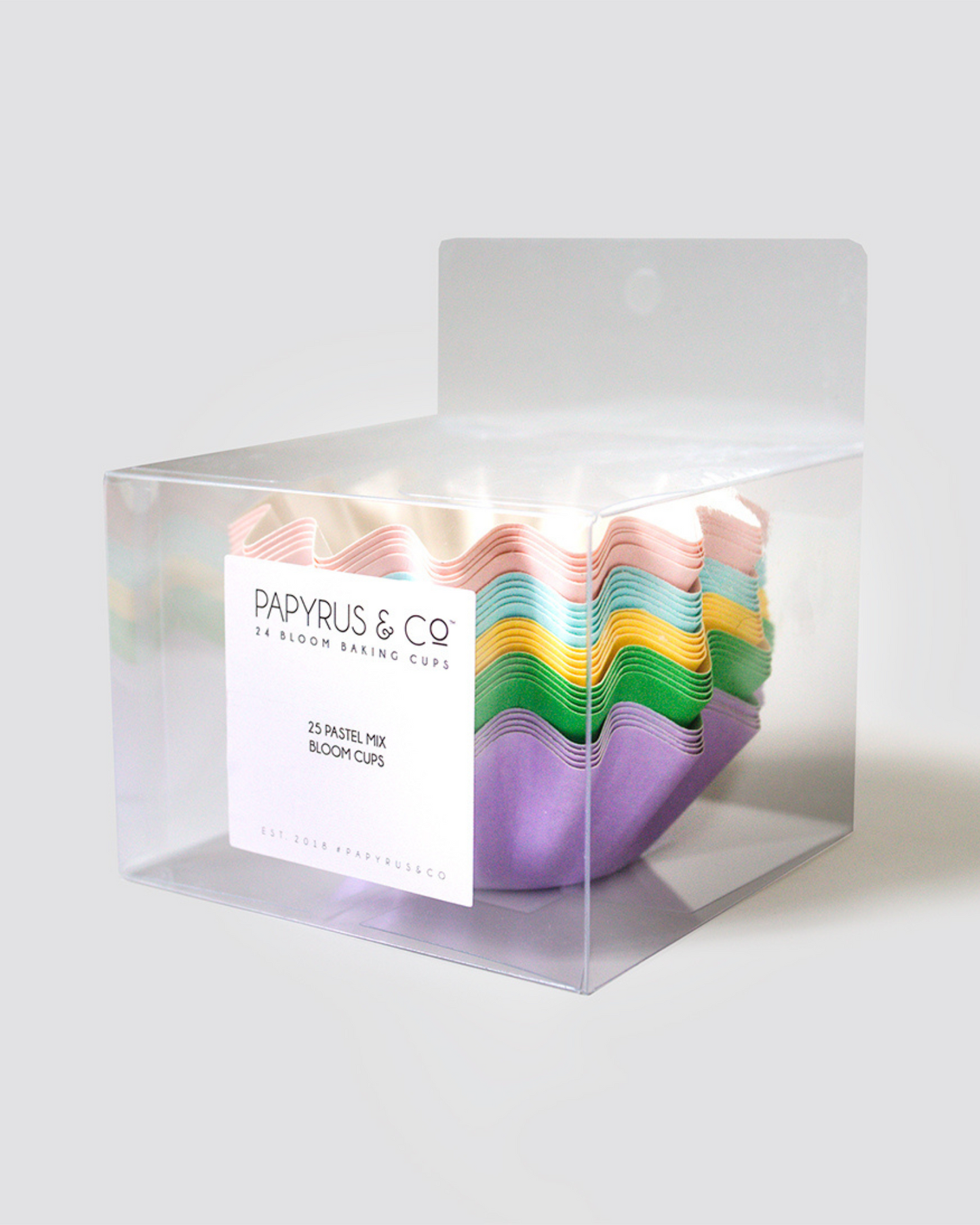 Pastel-colored baking cups arranged in a clear box, showcasing shades of pink, blue, green, yellow, and purple.