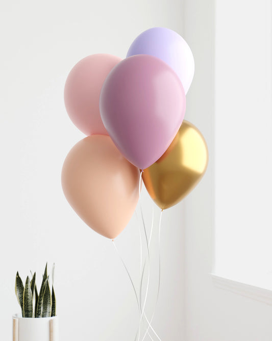 A cluster of pastel and metallic balloons in soft pink, lavender, and gold, gently swaying against a bright backdrop.