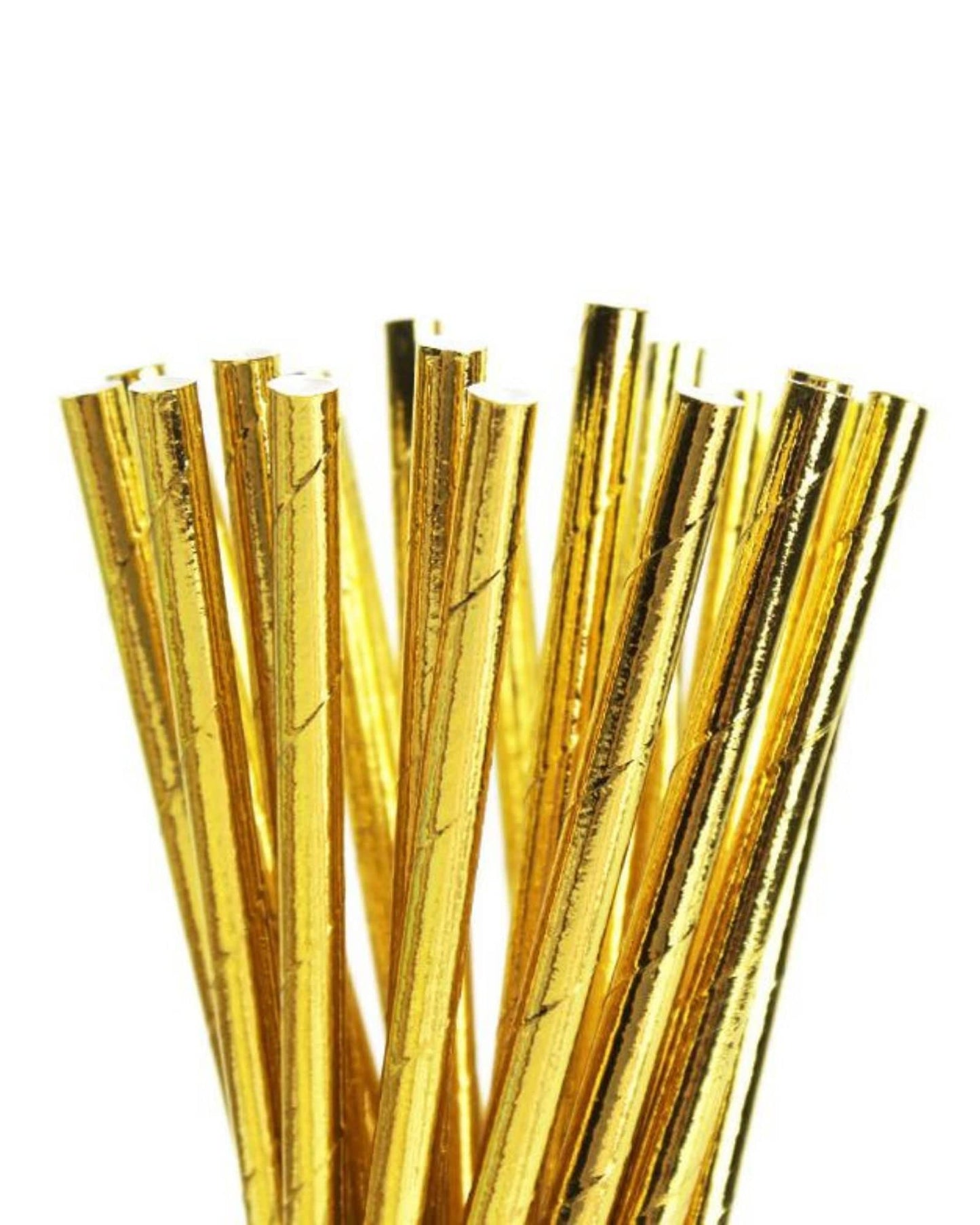 A bunch of shiny metallic gold straws with a textured surface, arranged closely together against a white background.