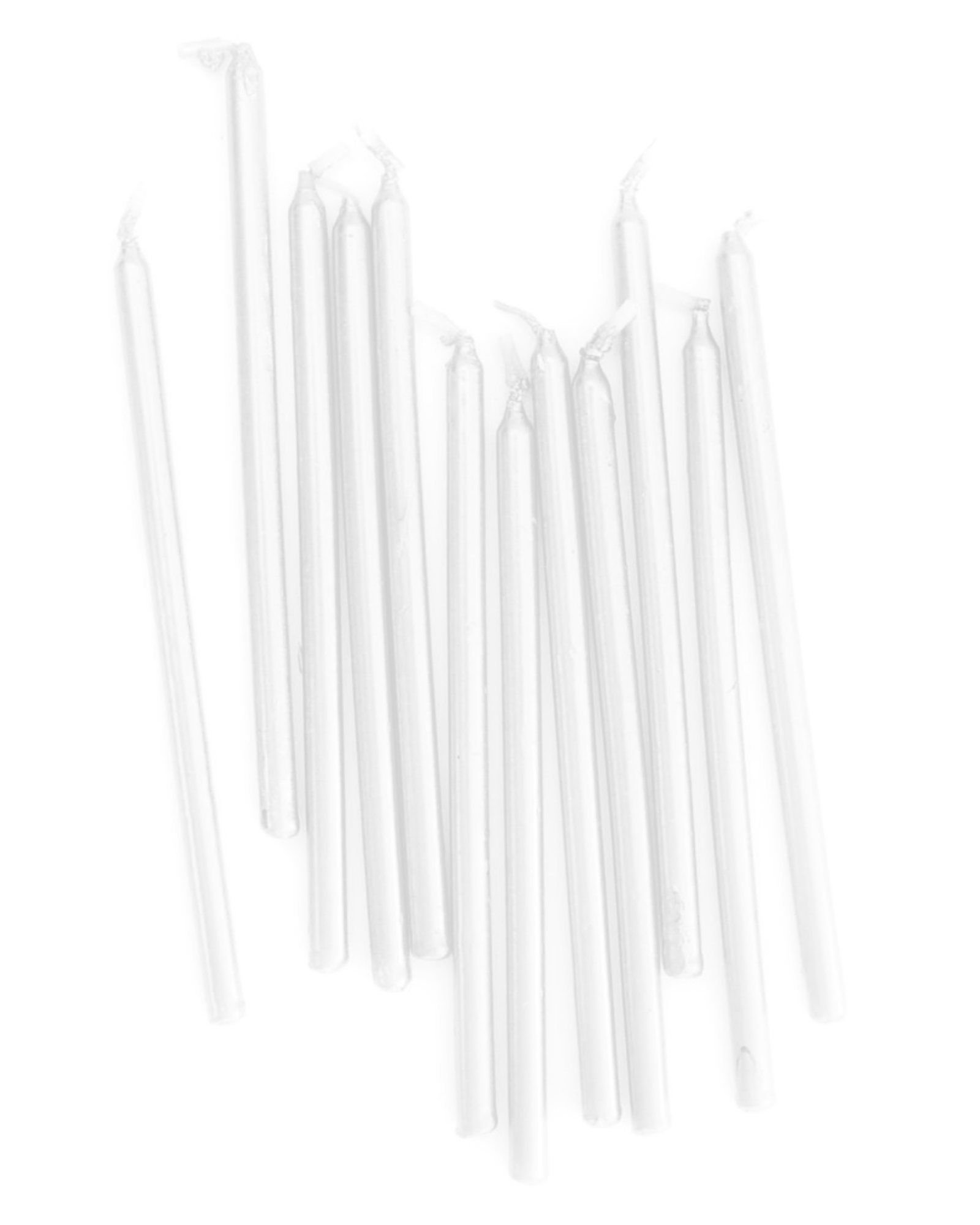 A collection of slender, pearl white candles arranged closely, featuring tapered tops and a smooth, glossy finish.