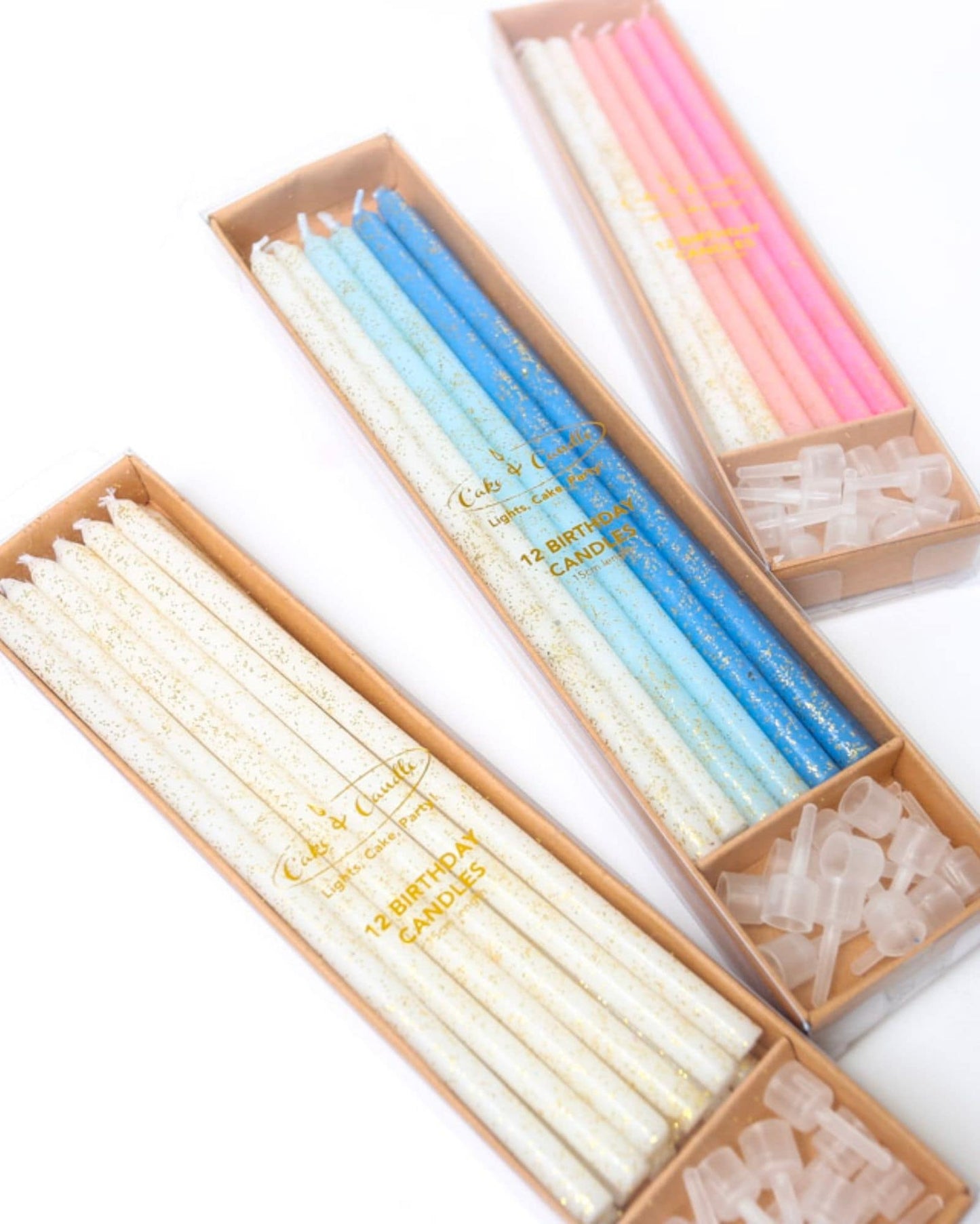 Colorful birthday candles in pastel shades of blue, pink, and white, featuring a sparkling glitter finish.