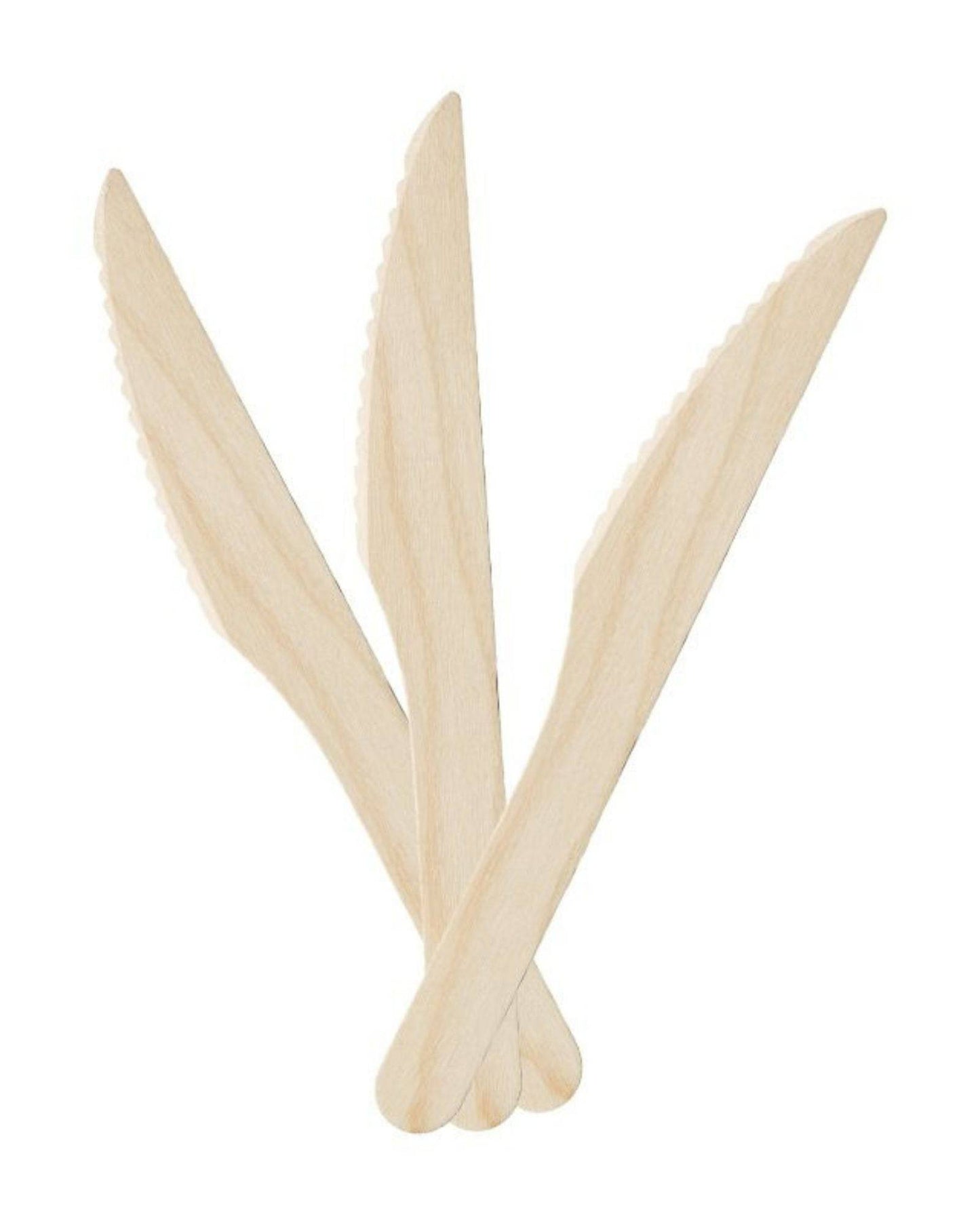 A set of three light-colored wooden knives with serrated edges, stacked together against a plain background.