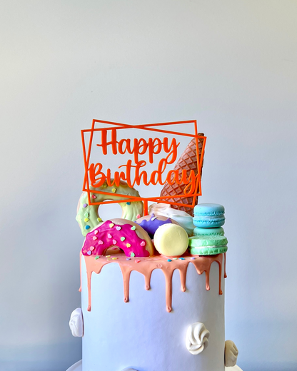 A colorful cake topped with playful decorations and a bright "Happy Birthday" sign.