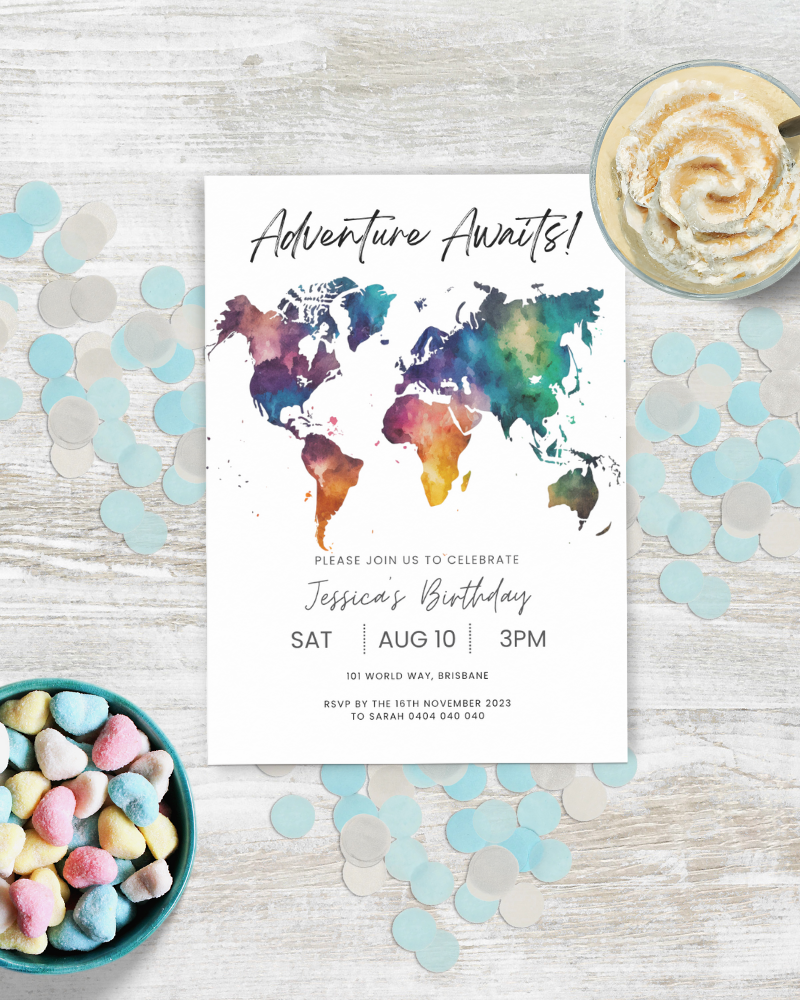 A colorful world map invitation for a birthday celebration, surrounded by pastel confetti and a dessert.