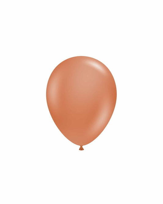 Single, smooth, brown balloon against a plain white background, reflecting soft light for a subtle shine.