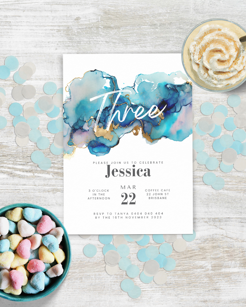 Colorful invitation featuring blue and gold watercolor, surrounded by confetti and heart-shaped candies.