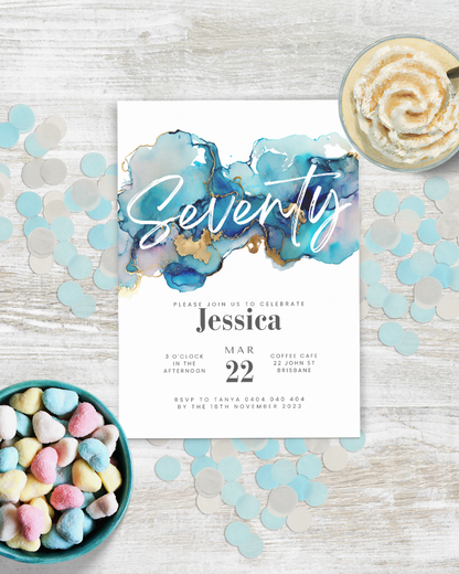 Colorful heart-shaped candies surround a festive invitation featuring watercolor blues and gold accents, celebrating a birthd