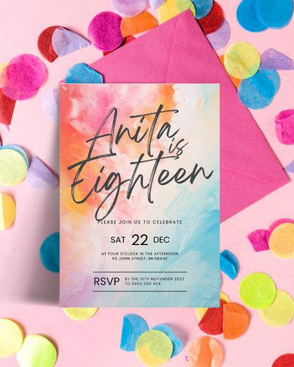 Colorful invitation card on a pink background, surrounded by vibrant confetti and a matching envelope.