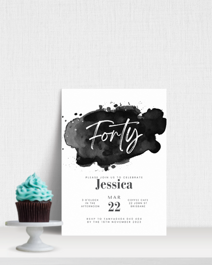 A modern invitation featuring elegant typography on a watercolor splash, accompanied by a cupcake with blue frosting.