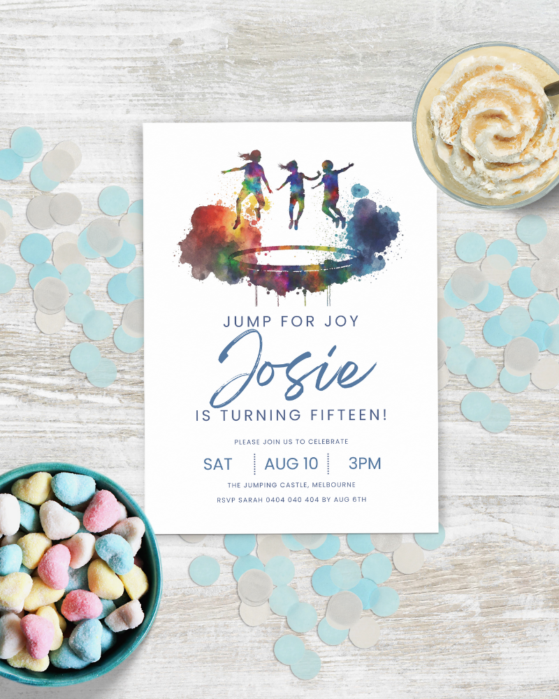 Colorful invitation featuring jumping figures, festive confetti, and a bowl of heart-shaped candies on a wooden surface.