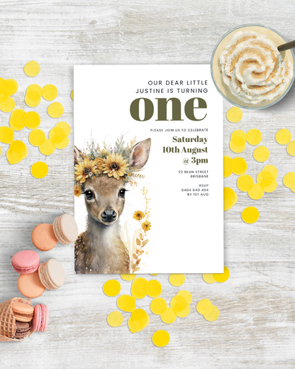 A charming invitation featuring a deer with a floral crown, surrounded by colorful confetti and sweet treats.