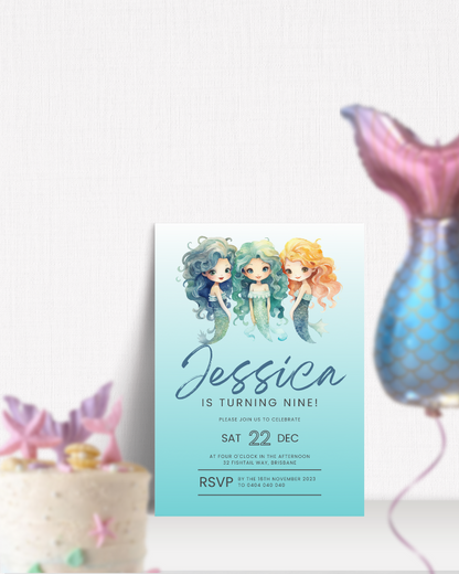 Colorful invitation featuring three mermaid characters with flowing hair, a cake, and a decorative shell motif.