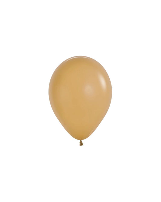 A glossy, golden balloon floats against a plain white background, showcasing its smooth surface and rounded shape.