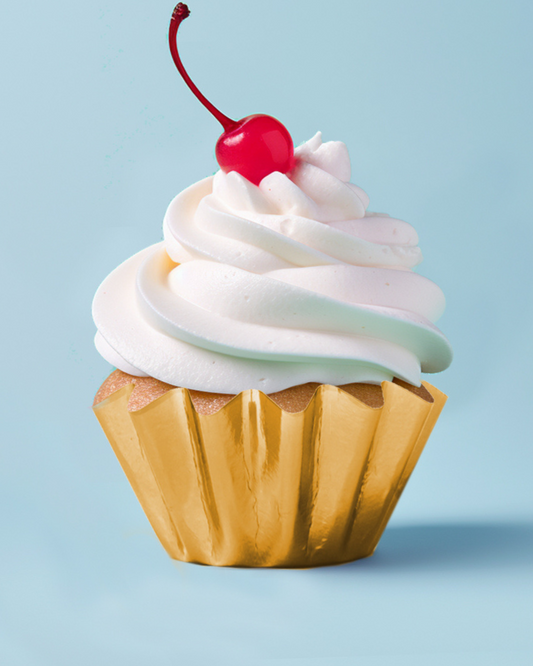 Whipped cream topped with a cherry on a golden base against a soft blue background.