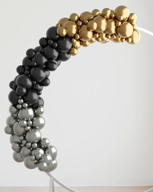 A curved arrangement of black, silver, and gold glossy spheres creates a striking decorative accent.