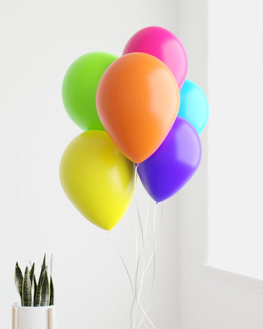 A vibrant cluster of balloons in shades of pink, green, orange, blue, yellow, and purple against a bright backdrop.