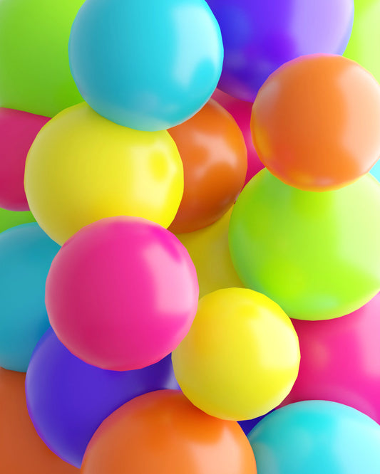 A vibrant mix of glossy balloons in various colors, including pink, yellow, green, blue, and orange, tightly packed together.