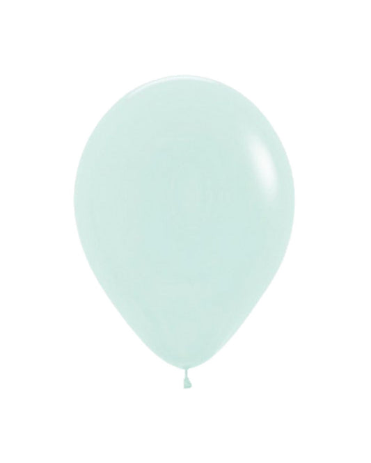 Pastel matte green balloon with a smooth surface, hanging gently against a plain white backdrop.