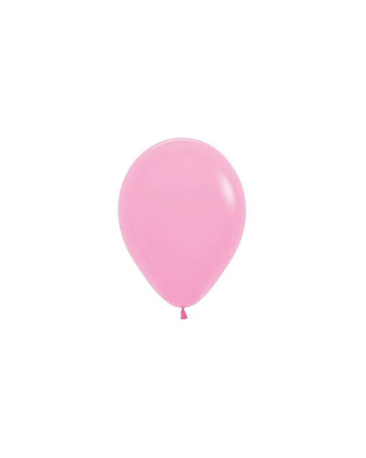 A shiny, light pink balloon with a smooth surface, gently tapering towards the tied end, set against a white background.