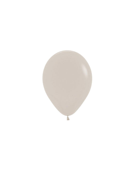 Light beige, round balloon with a smooth surface, gently tapering to a tied end, set against a plain background.