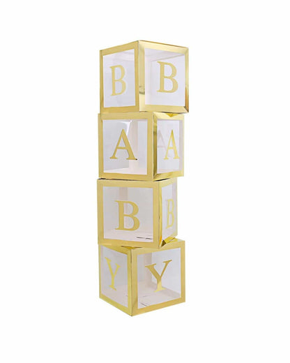 A stack of transparent cubes with gold frames displaying the letters B, A, B, Y in bold typography.