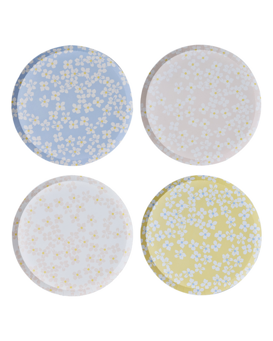 Four round surfaces in pastel colors featuring delicate floral patterns in white and yellow.