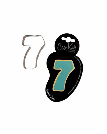 Metallic cutter shaped like the number seven, paired with a colorful backing card featuring the same design.