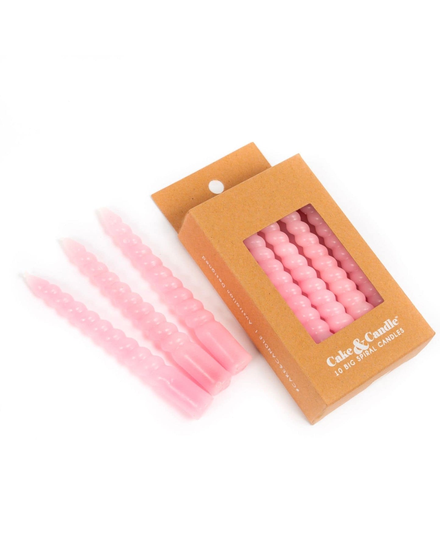 Set of four spiral-shaped pastel pink candles in a simple brown packaging with a clear window.