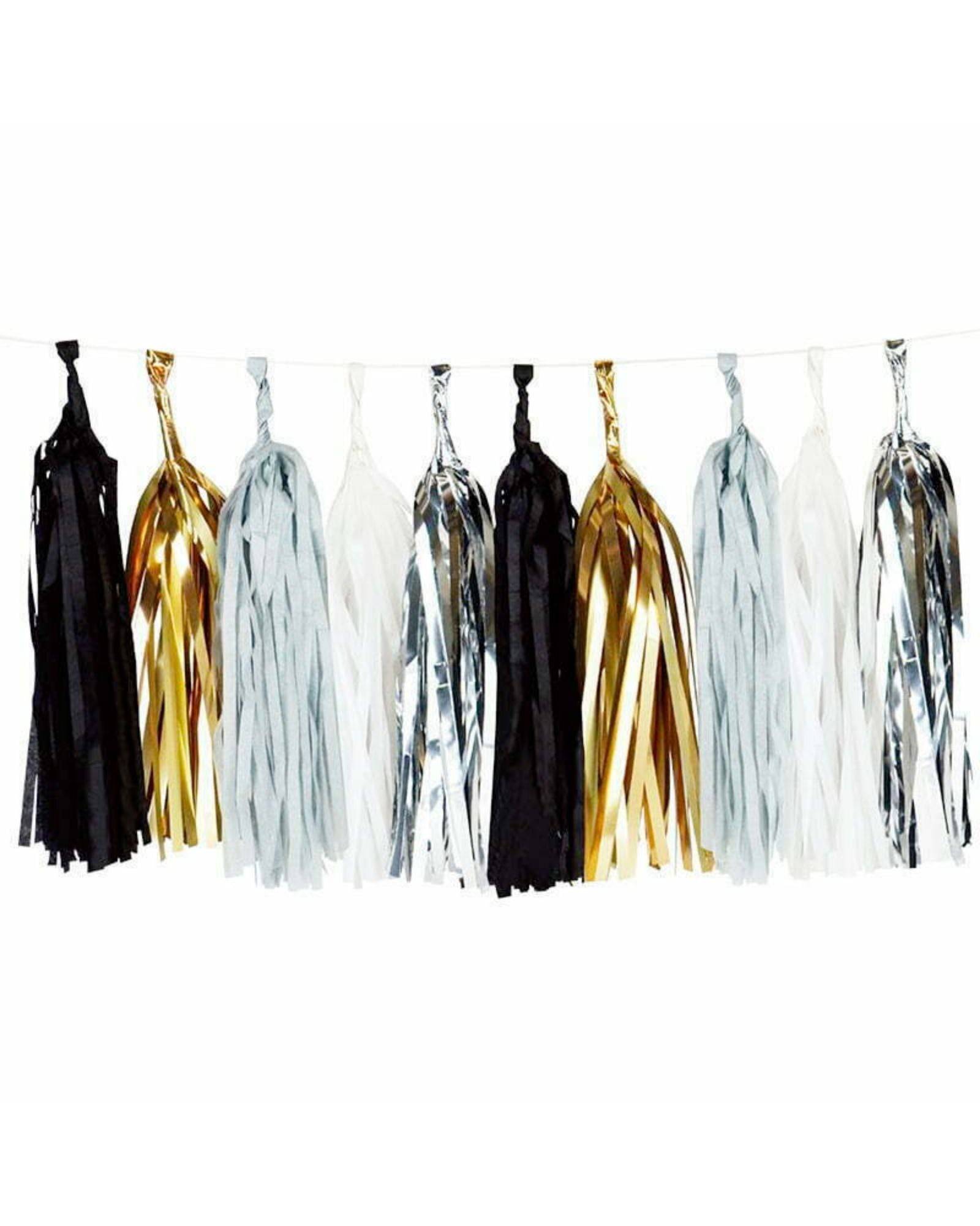 A colorful garland featuring black, white, silver, and gold tassels, perfect for festive decorations.