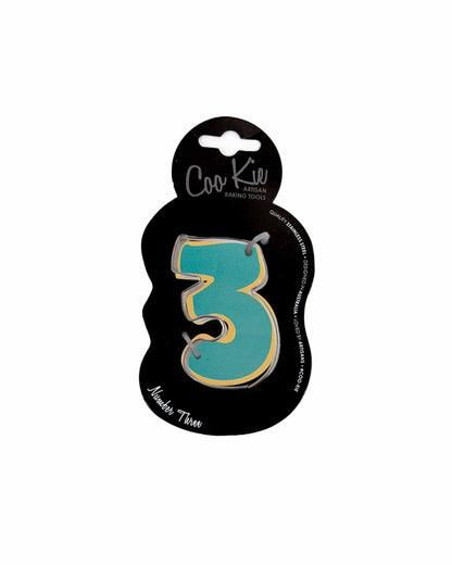 A vibrant, teal number three with a yellow outline, mounted on a sleek black backing. Perfect for celebrations.