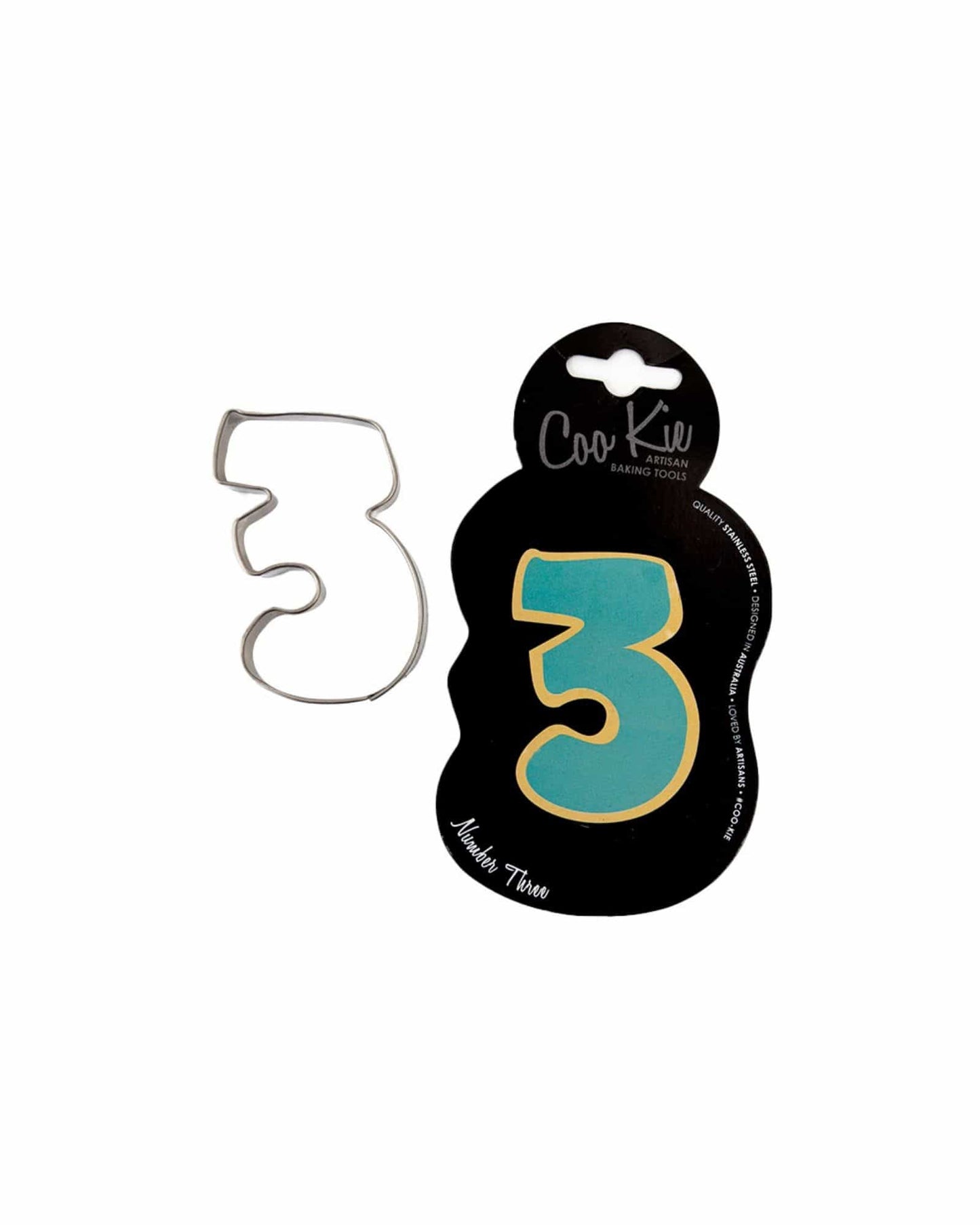 A metal cutter shaped like the number three, displayed on a black backing with colorful accents.