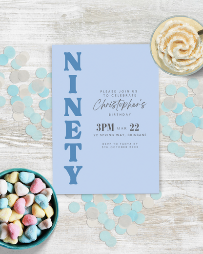 Blue invitation card for a birthday celebration, surrounded by colorful heart-shaped candies and confetti.