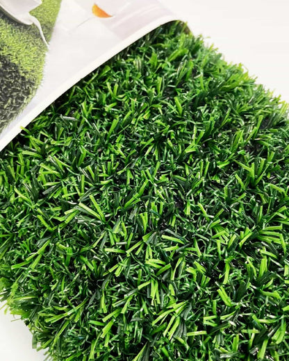 Vibrant green artificial grass with varying shades and textures, showcasing a lush, manicured appearance.