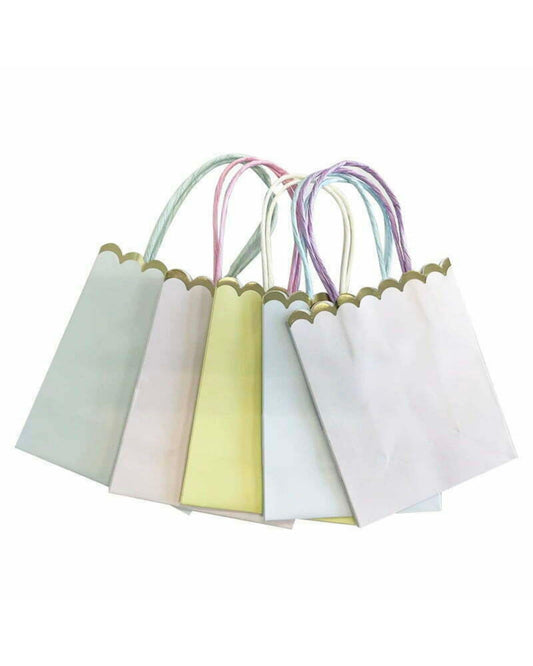 A collection of pastel-colored bags with scalloped edges and colorful twisted handles arranged together.