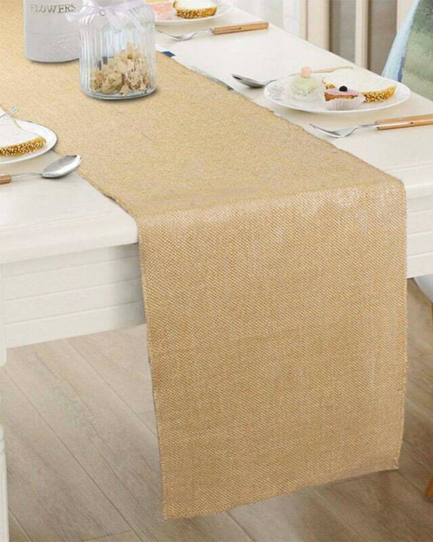 A textured, neutral-colored runner drapes elegantly over a table, complementing plates and utensils nearby.