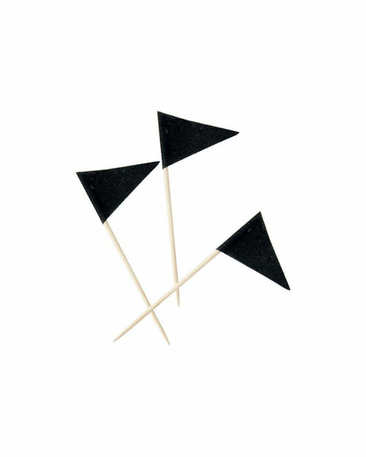 Three small black triangular flags on wooden sticks against a white background.