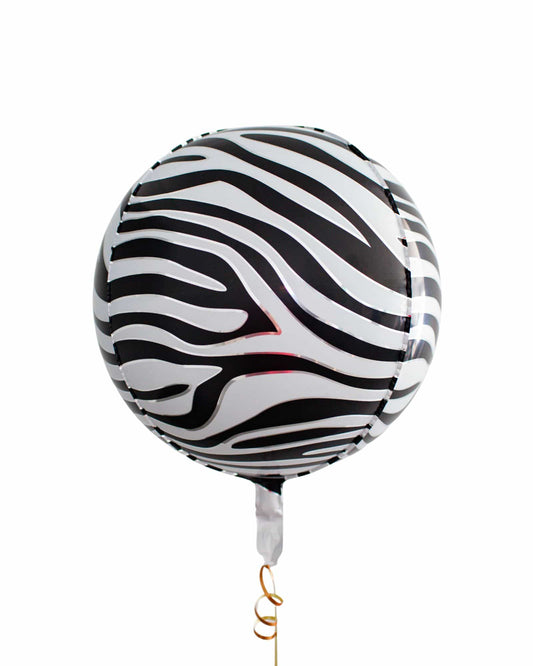 A round decoration with a striking black and white zebra stripe pattern, tied with a golden string.