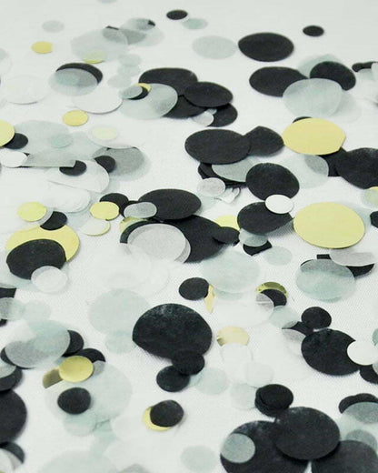 A scattered arrangement of various-sized circles in black, gray, and yellow on a light background.