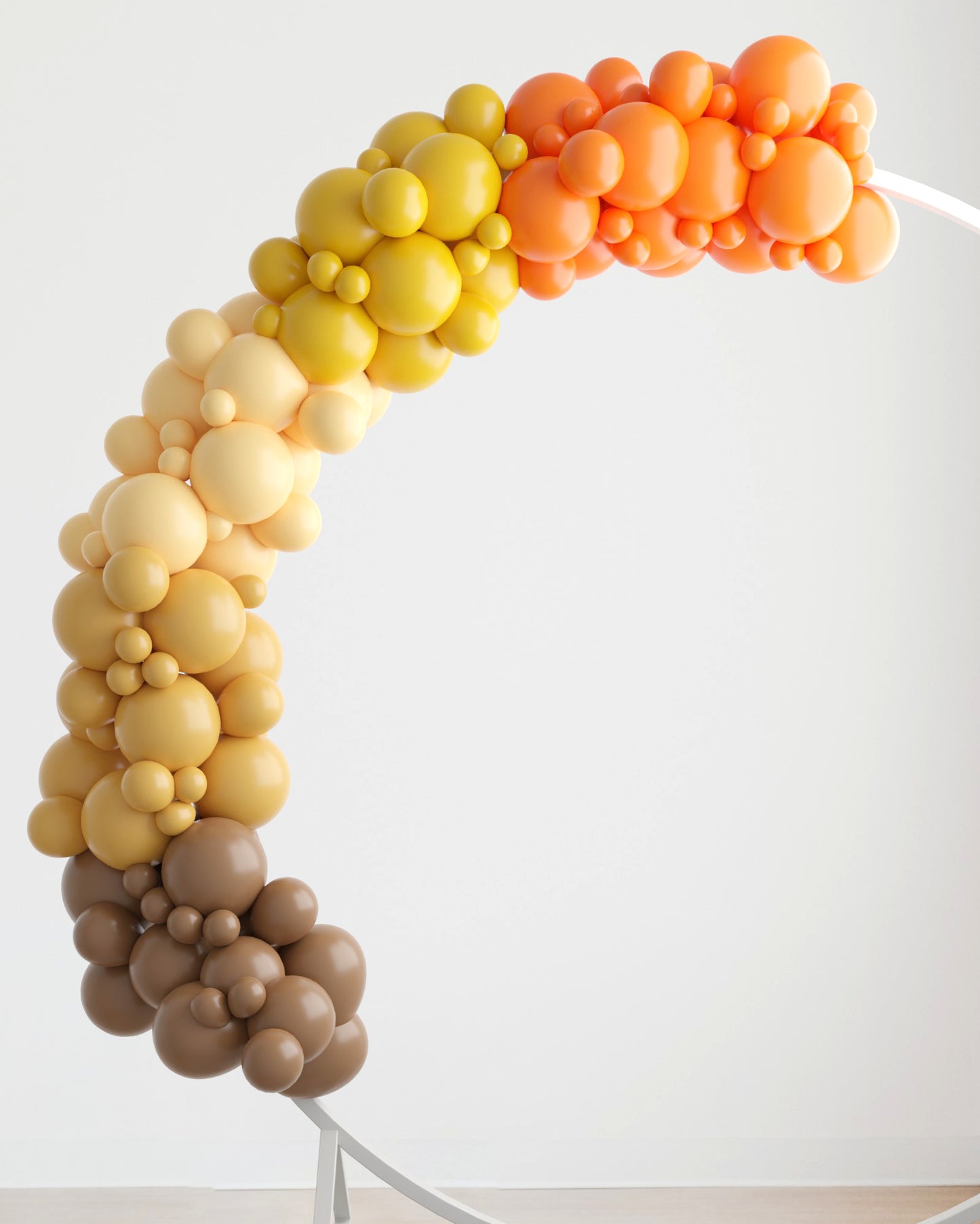 Colorful balloon garland in warm autumn hues of orange, yellow, and brown, elegantly arching against a light background.