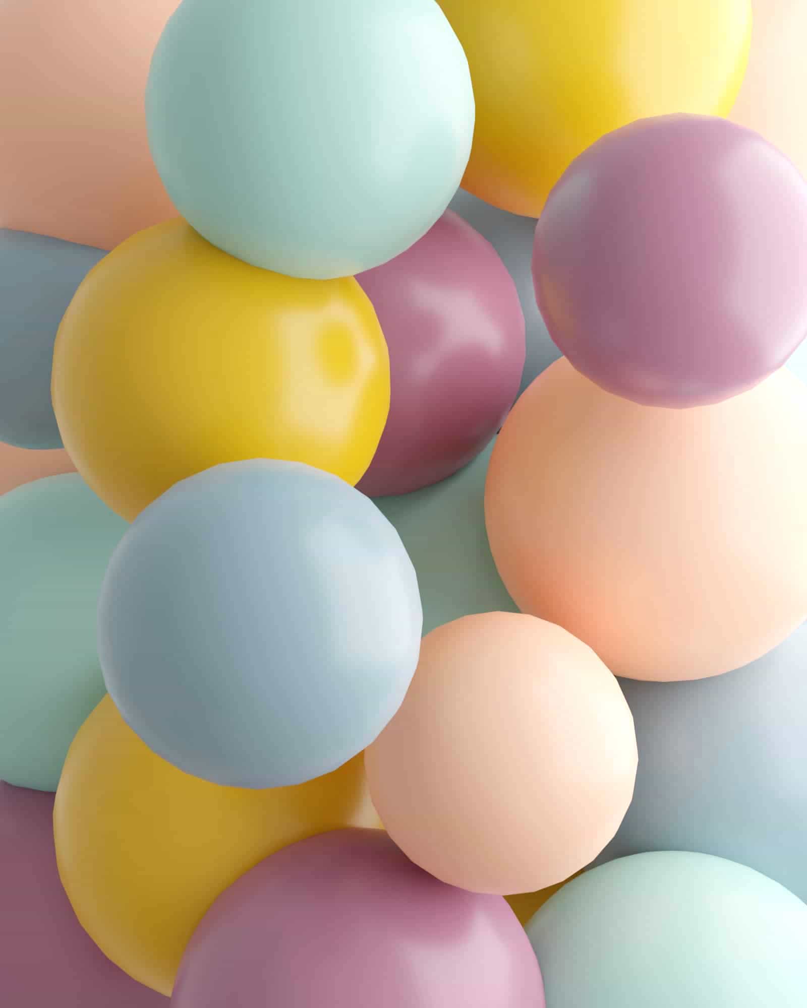 A colorful arrangement of glossy, pastel-hued spheres in shades of blue, yellow, pink, and peach, creating a playful look.