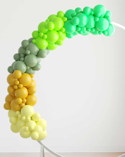 A vibrant garland of green, yellow, and gray balloons arranged in a playful arch against a light background.