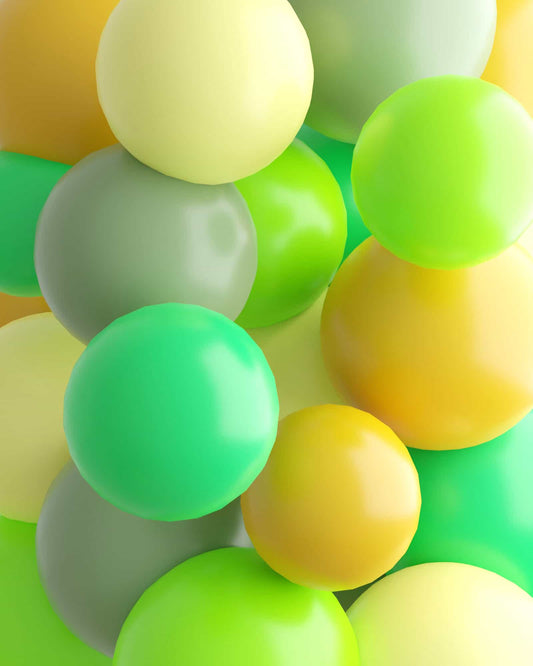 A cluster of glossy, colorful spheres in shades of green and yellow create a vibrant, playful composition.