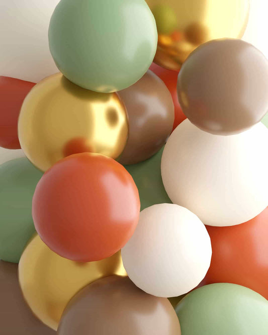 A vibrant mix of glossy spheres in earthy tones, including green, gold, brown, and red, creating a playful arrangement.