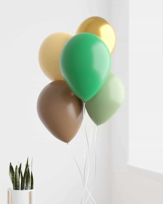 A cluster of colorful balloons in green, gold, and brown against a bright background with a potted plant nearby.