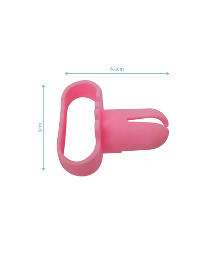 A pink silicone tool with a loop and a small gripping feature, measuring 6.5 cm wide and 5 cm tall.