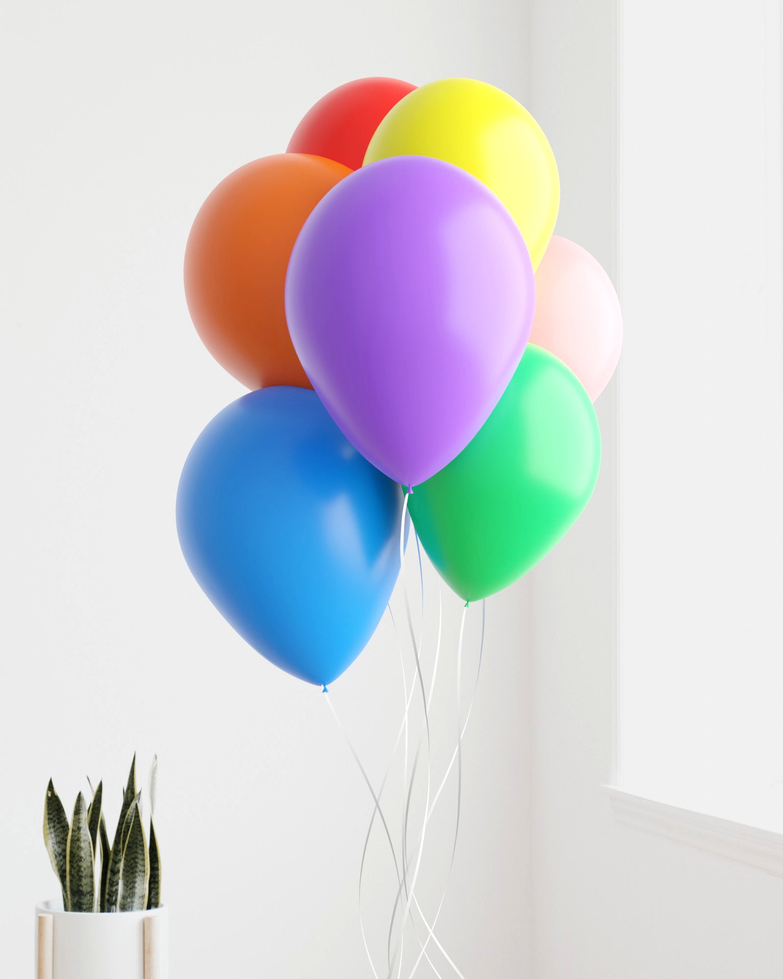 A vibrant bunch of balloons in red, orange, yellow, green, blue, purple, and pink floating against a bright background.