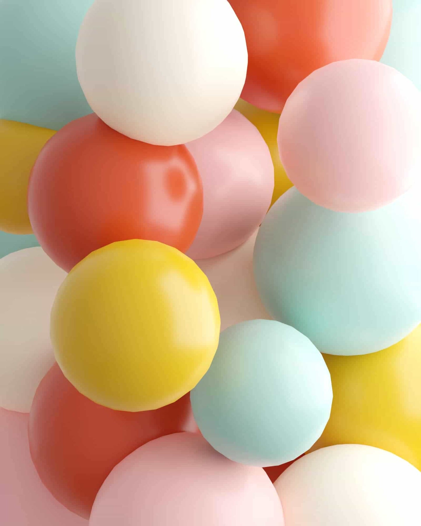 Colorful spheres in pastel shades of pink, yellow, blue, and red arranged in a playful, overlapping composition.