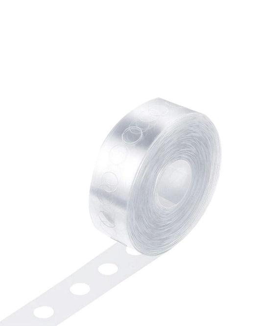 Clear adhesive strip with circular cutouts, ideal for securing and displaying decorations or crafts.